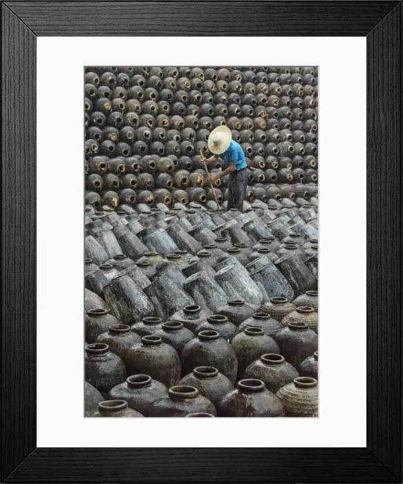 Framed Print : Man in the middle of big pile of wine jars stacked up at a local rice winery, Wuxi Framed Print : Man in the middle of big pile of wine jars stacked up at a local rice winery, Wuxi