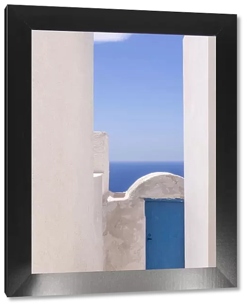 Europe, Greece, Thirasia. White building and blue door and ocean