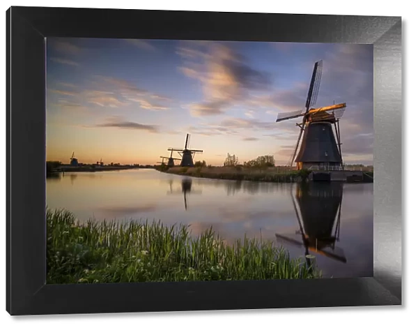 Europe, The Netherlands. Kinderdijk windmills at sunset
