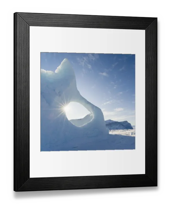 Framed Print : Iceberg frozen into the sea ice of the Uummannaq fjord system during winter Framed Print : Iceberg frozen into the sea ice of the Uummannaq fjord system during winter