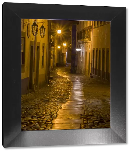 Portugal, Obidos. Walkway along the walled town of Obidos at night