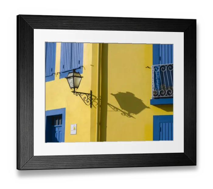 Framed Print : Portugal, Aveiro. Shadow of street lantern on colorful yellow building with bright blue Framed Print : Portugal, Aveiro. Shadow of street lantern on colorful yellow building with bright blue