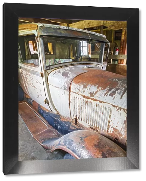 Latah, Washington State, USA. Rusted vintage Ford Model A pickup truck in a barn