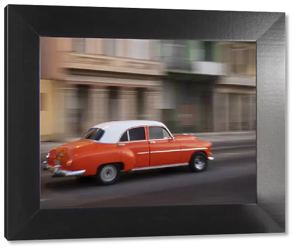 Cuba, Havana, Havana Vieja, UNESCO World Heritage Site, classic red car in motion