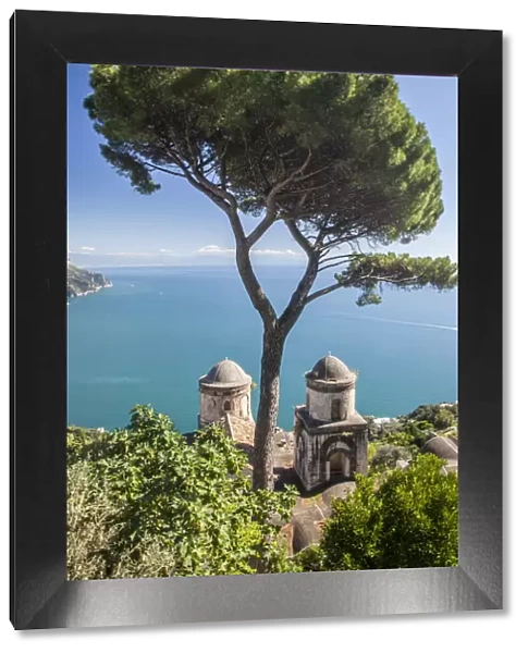 Italy, Campania, Ravello. View of the Amalfi Coast and the towers of Villa Rufolo in the hilltop town of Ravello