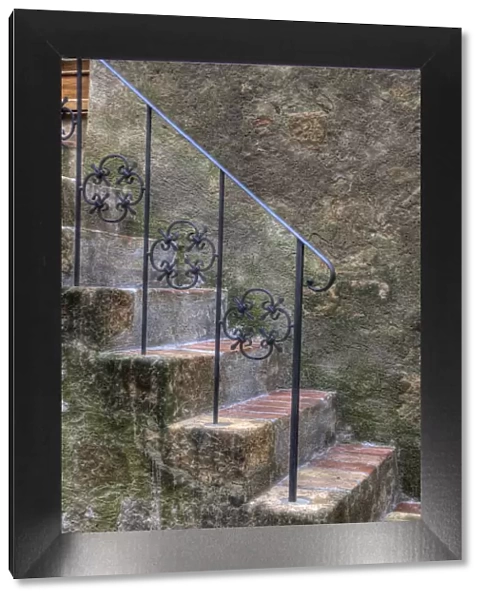Italy, Tuscany, Pienza. Steps with wrought iron railing leading to the entrance to a home in Pienza
