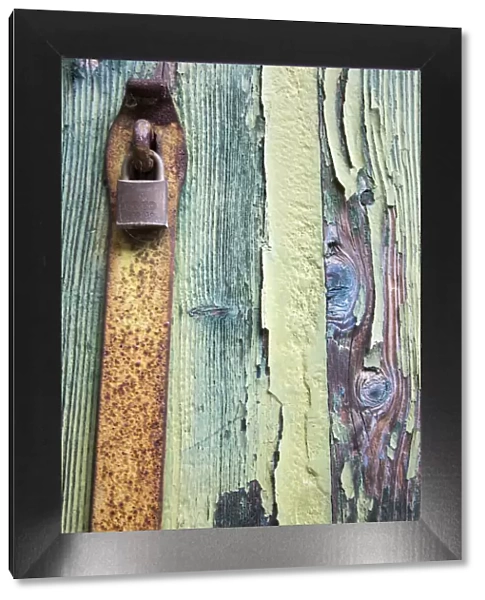 Italy, Venice, Burano Island. Patterns of peeling paint and padlock on old wooden doors