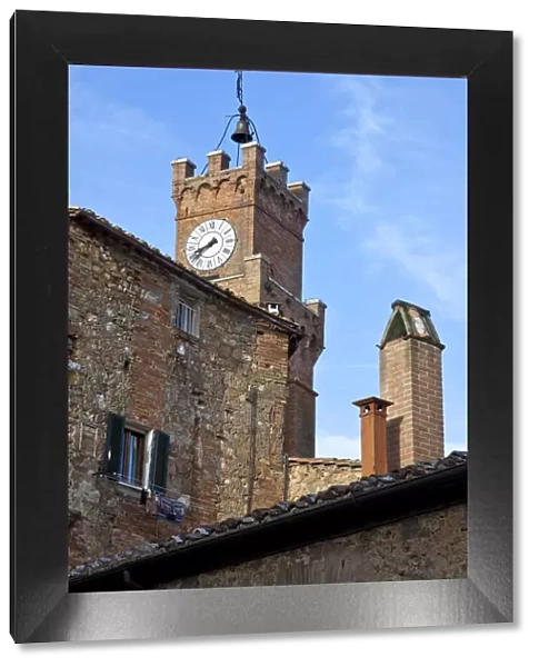 Italy, Tuscany, Pienza. The town hall clock tower in the town of Pienza