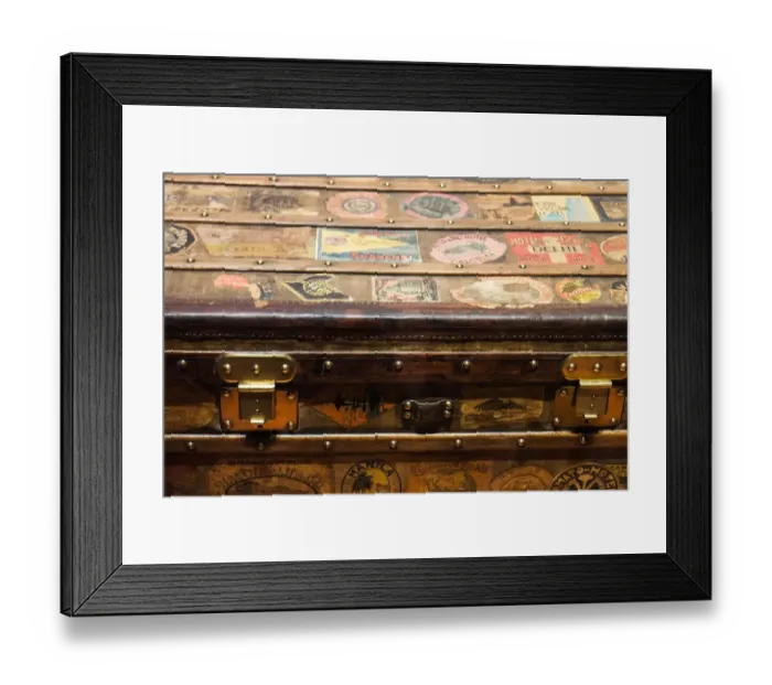 Framed Print : Old steamer trunk covered with stickers of various destinations