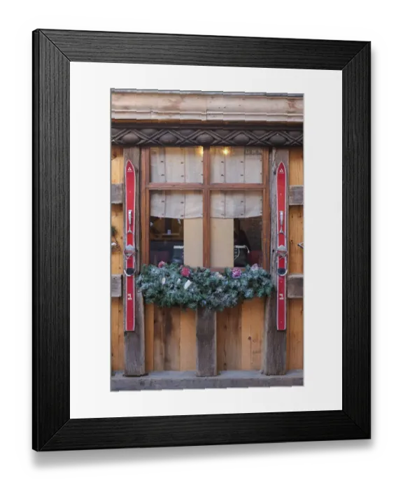 Framed Print : Colmar, France. Old town Colmar adorned with Christmas decoration. Old skis decorate a rustic cafe with a ski theme