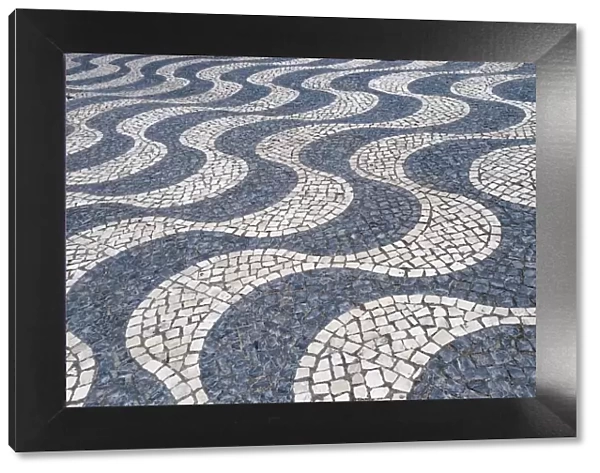 Cascais, Portugal Europe. Typical Portuguese tiled sidewalk in black and white pattern