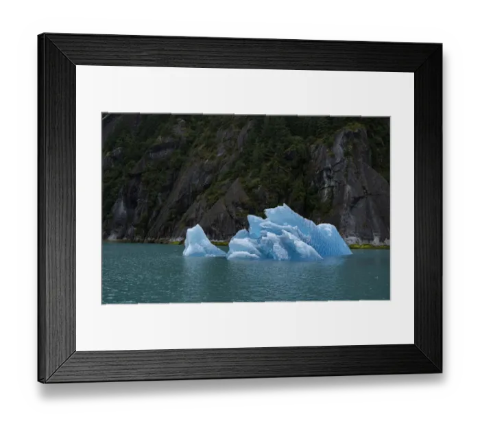 Framed Print : Usa, Alaska. This perfect iceberg floats in the blue waters of Endicott Arm near a steep glacially carved cliff Framed Print : Usa, Alaska. This perfect iceberg floats in the blue waters of Endicott Arm near a steep glacially carved cliff