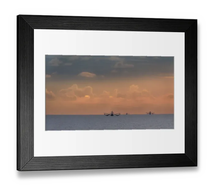 Framed Print : Fishing boats deep out to sea against the backdrop of dramatic sunset clouds and sky Framed Print : Fishing boats deep out to sea against the backdrop of dramatic sunset clouds and sky