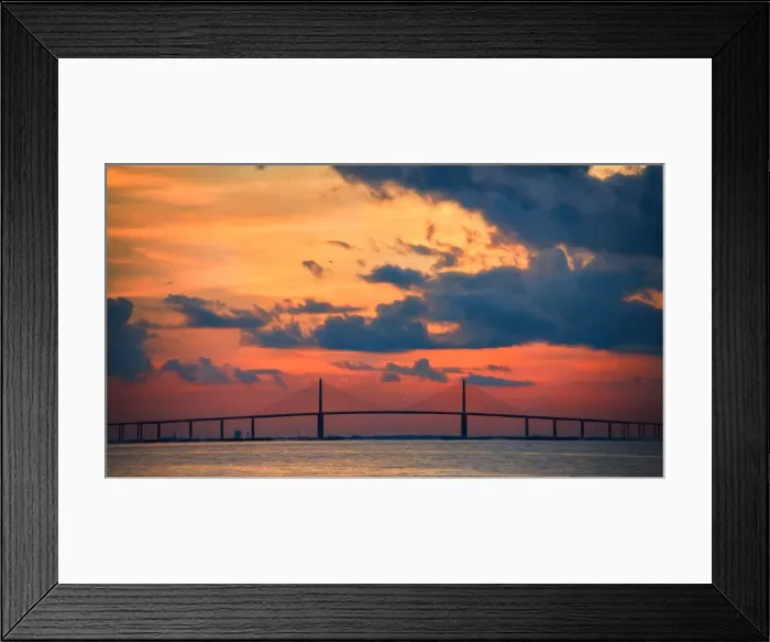 Framed Print : The Skyway Bridge over the Gulf of Mexico with the reds and oranges of the sunrise in the sky