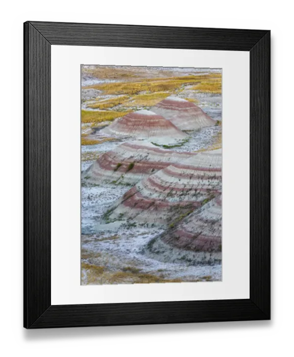 Framed Print : A half circle of rounded mounds or hoodoo, sharply striated with reds Framed Print : A half circle of rounded mounds or hoodoo, sharply striated with reds