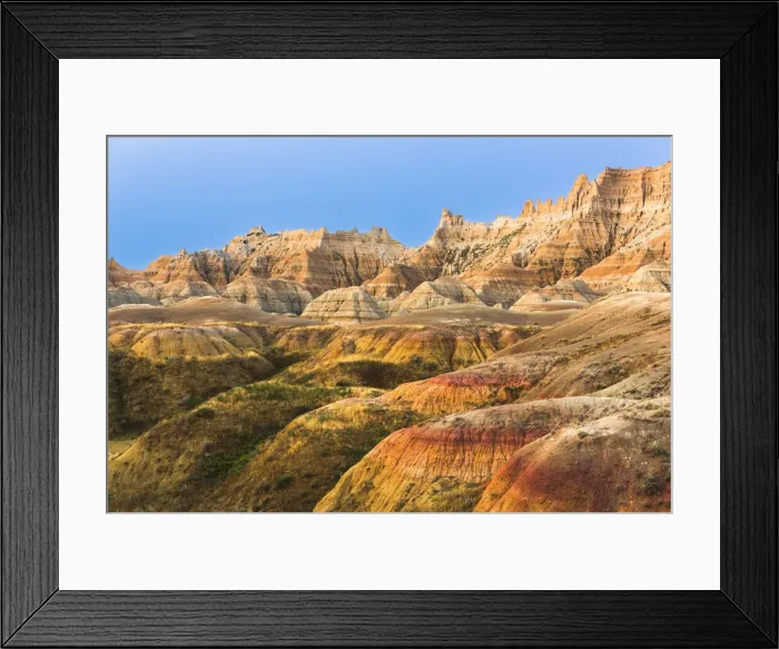 Framed Print : Layers of striated round hoodoos lead to soaring sharp peaked hoodoos reflecting sunset oranges against the deep blue sky Framed Print : Layers of striated round hoodoos lead to soaring sharp peaked hoodoos reflecting sunset oranges against the deep blue sky