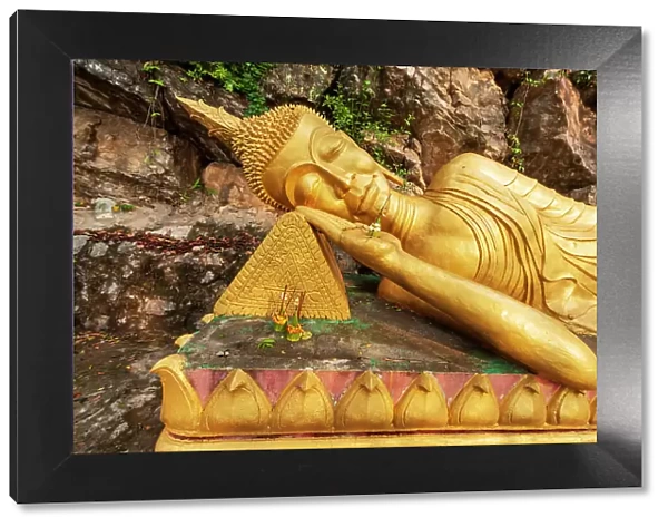 Laos, Luang Prabang. Reclining Buddha statue on Mount Phousi