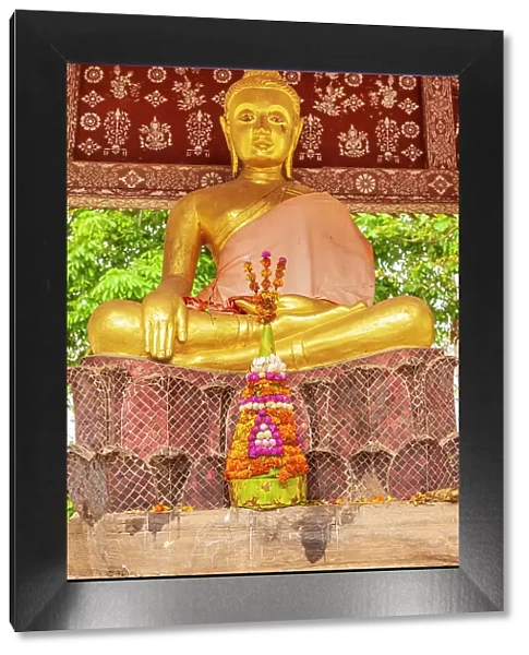 Laos, Luang Prabang. Golden Buddha statue and altar
