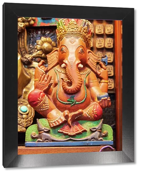 Thailand, Bangkok. Carved and painted wooden statue of Ganesha, or Phra Phikanet
