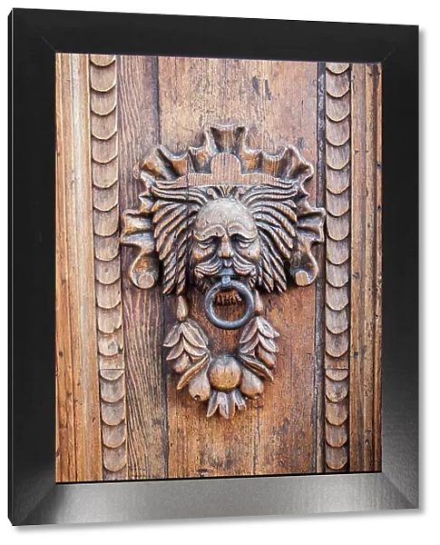 Italy, Umbria, Assisi. Ornate wood carved door knocker