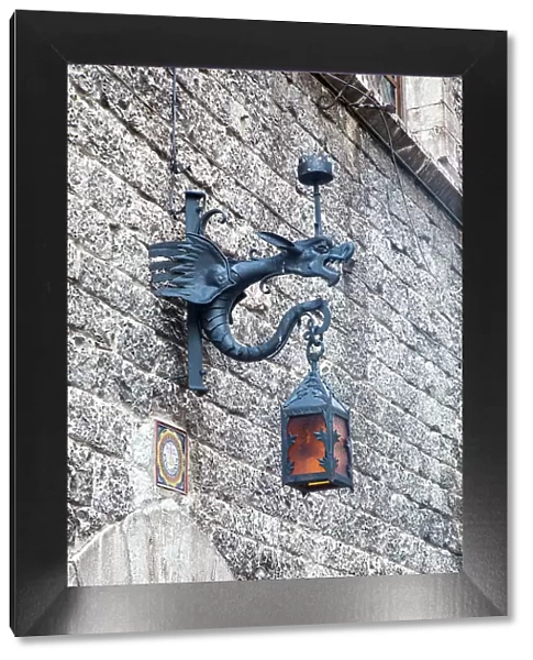 Italy, Umbria, Assisi. Old stone wall with Dragon Lantern