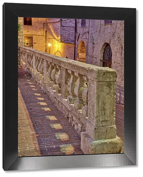 Italy, Umbria, Assisi. Short stone wall with columns near the Convento Chiesa Nuova