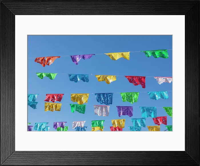 Framed Print : Todos Santos, Baja California Sur, Mexico. Festive colorful banners over a street