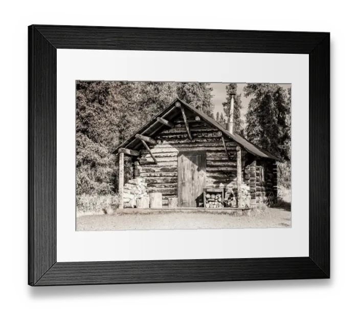 Framed Print : Small, rustic log home in sepia