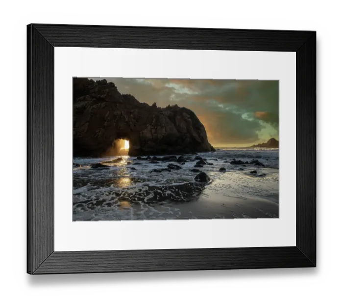 Framed Print : Sunset shines through a tunnel in this sea rock at Big Sur
