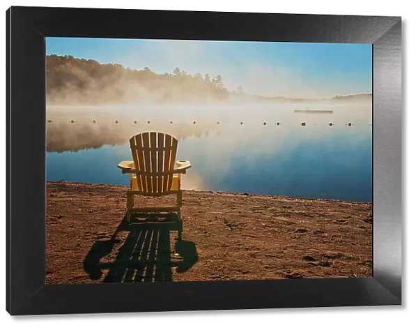 Canada, Ontario, Silent Lake Provincial Park. Muskoka chair and morning fog on Silent Lake