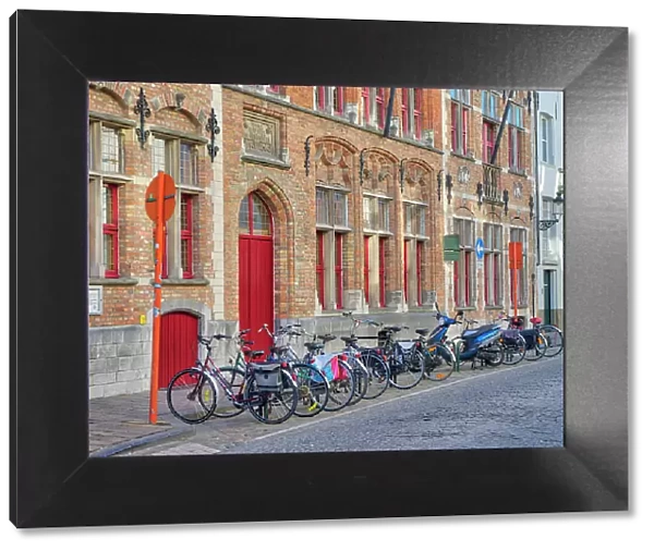 Belgium, Brugge. Bicycles parked along the street