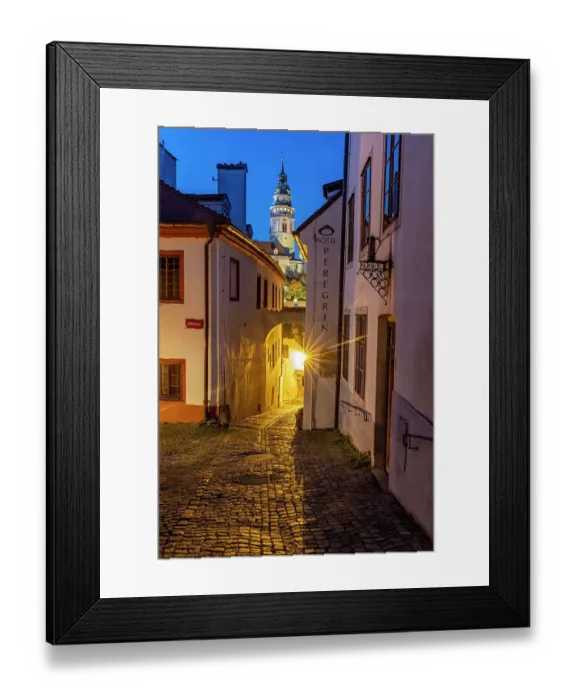 Framed Print : Narrow cobblestone streets at dusk with Castle Tower in historic Cesky Krumlov, Czech Republic. (Editorial Use Only) Framed Print : Narrow cobblestone streets at dusk with Castle Tower in historic Cesky Krumlov, Czech Republic. (Editorial Use Only)