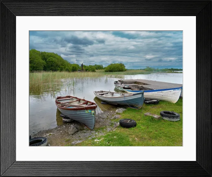 Framed Print : Boats await skippers on Lough Carra, County Mayo, Ireland. Shrine watches over the fishermen