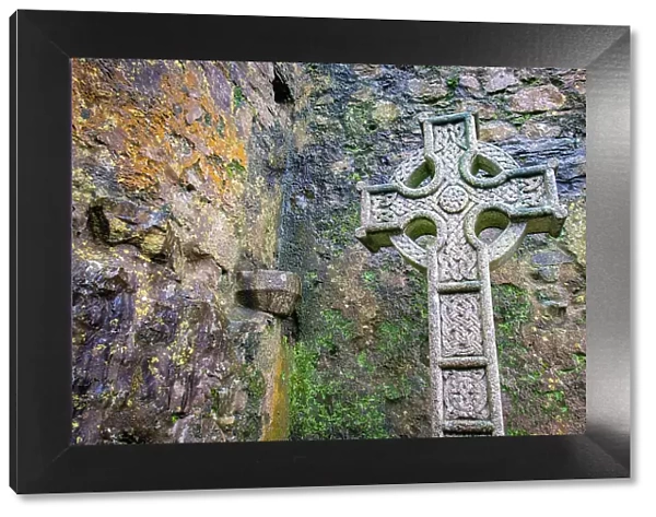 Elaborate Celtic cross marks a grave at a historic Irish church, County Mayo, Ireland
