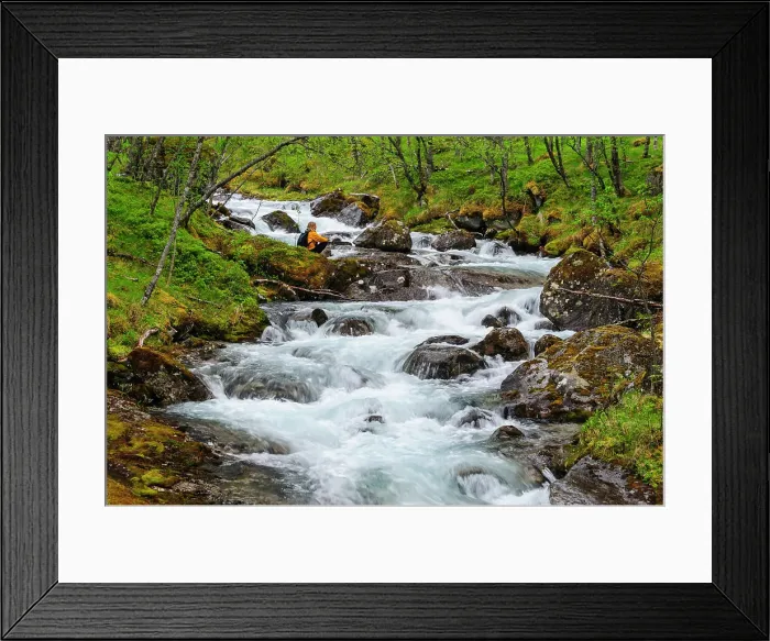 Framed Print : Norway, Nordland, Tysfjord. Woman sitting along Storelva, the river that flows from Stetind (Norway's national mountain). (MR) Framed Print : Norway, Nordland, Tysfjord. Woman sitting along Storelva, the river that flows from Stetind (Norway's national mountain). (MR)