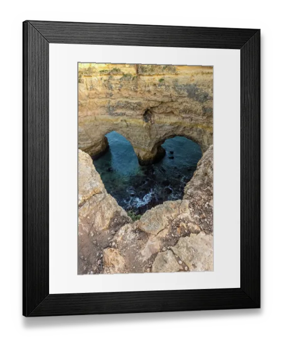 Framed Print : Portugal. Heart-shaped rock design on shore