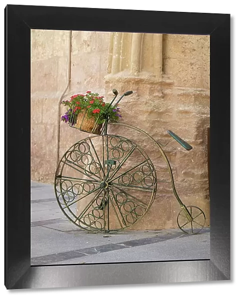 Cordoba, Spain. Bicycle planter in front of old stone building