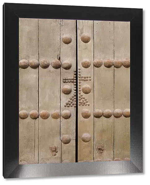 Cordoba, Spain. Ancient wooden door with cross