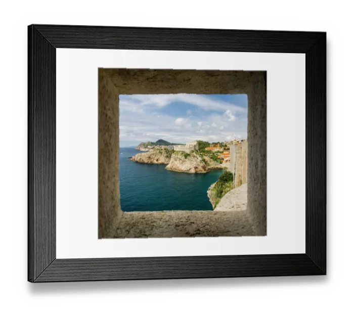 Framed Print : Croatia, Dubrovnik. Ancient fortress on the cliff edge of Dubrovnik protects the port as seen from through a window on the wall surrounding the city Framed Print : Croatia, Dubrovnik. Ancient fortress on the cliff edge of Dubrovnik protects the port as seen from through a window on the wall surrounding the city