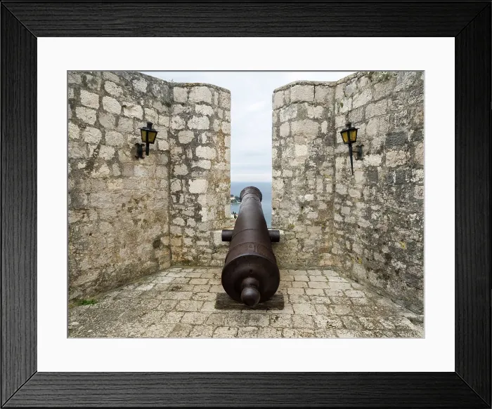 Framed Print : Croatia, Hvar. Old cannon overlooking the island town and coastline from Hvar Fortica or Spanjola Fortress