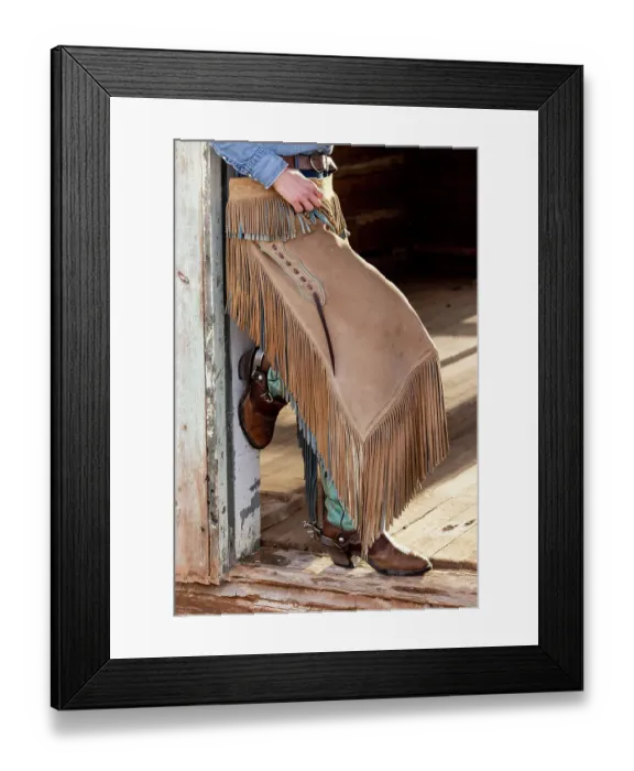 Framed Print : USA, Shell, Wyoming. Hideout Ranch cowgirl standing in doorway with cowboy boots and chaps. (PR, MR) Framed Print : USA, Shell, Wyoming. Hideout Ranch cowgirl standing in doorway with cowboy boots and chaps. (PR, MR)