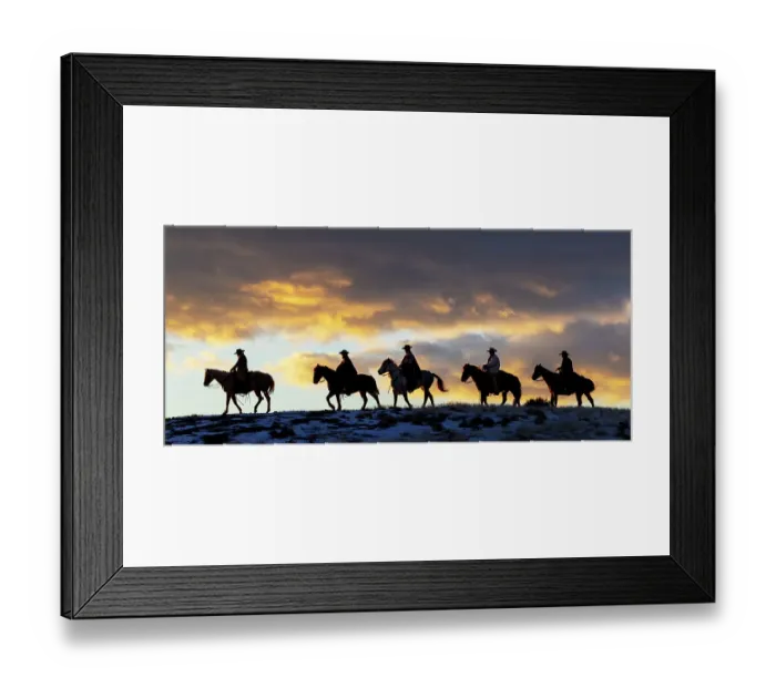 Framed Print : USA, Shell, Wyoming. Hideout Ranch cowboys and cowgirls silhouetted against sunset riding on ridgeline. (PR, MR)