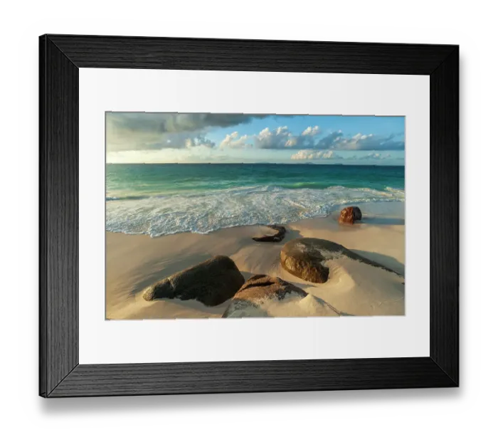 Framed Print : Surf surging towards boulders buried in sand on a tropical beach. Anse Victorin Beach, Fregate Island, Seychelles Framed Print : Surf surging towards boulders buried in sand on a tropical beach. Anse Victorin Beach, Fregate Island, Seychelles