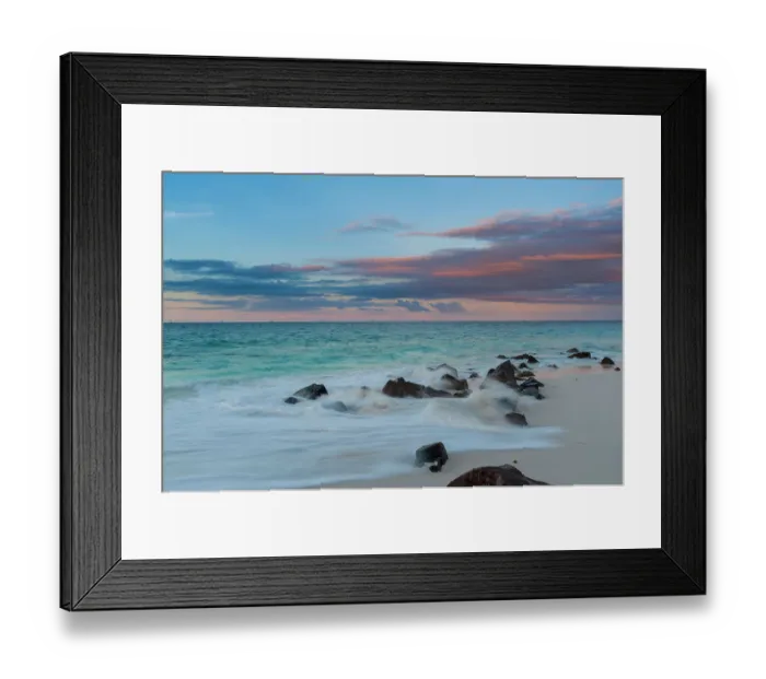Framed Print : Long exposure of Indian Ocean surf surging onto a rocky beach at sunset. Anse Bambous Beach, Fregate Island, Seychelles