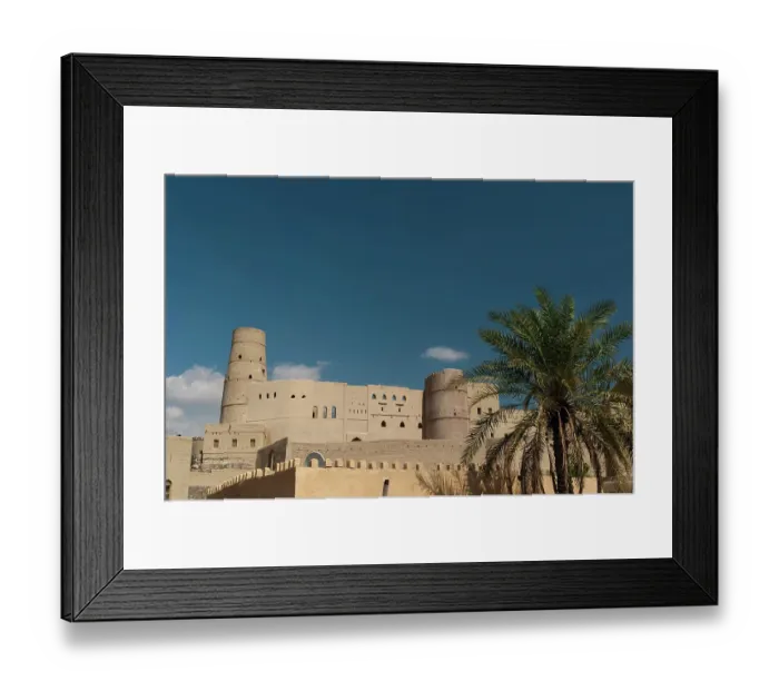 Framed Print : The Bahla fort, built in 13th century, and a palm tree. Bahla, Oman Framed Print : The Bahla fort, built in 13th century, and a palm tree. Bahla, Oman