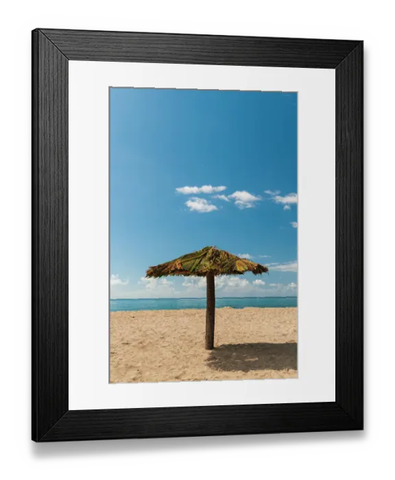 Framed Print : A tiki umbrella on a palm tree trunk on Pinney's white sand beach. Nevis Island, West Indies Framed Print : A tiki umbrella on a palm tree trunk on Pinney's white sand beach. Nevis Island, West Indies