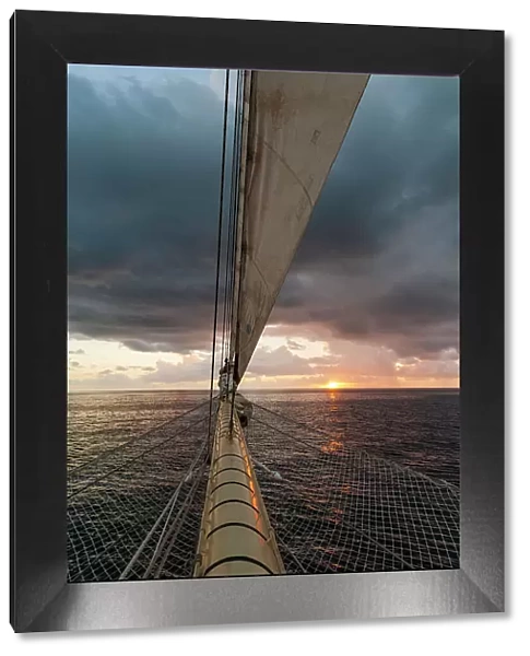 A view of the sunrise from the prow of a Star Clipper cruise ship sailing in the Caribbean near Nevis Island. Caribbean Sea near Nevis Island, West Indies