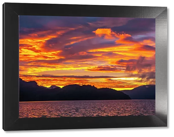 Canada, British Columbia, Inside Passage. Sunrise on ocean and mountains