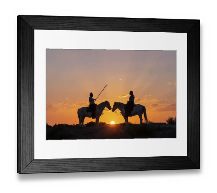 Framed Print : Saintes-Maries-de-la-Mer, Bouches-du-Rhone, Provence-Alpes-Cote d'Azur, France. Man and a woman on horseback at sunrise. (Editorial Use Only)