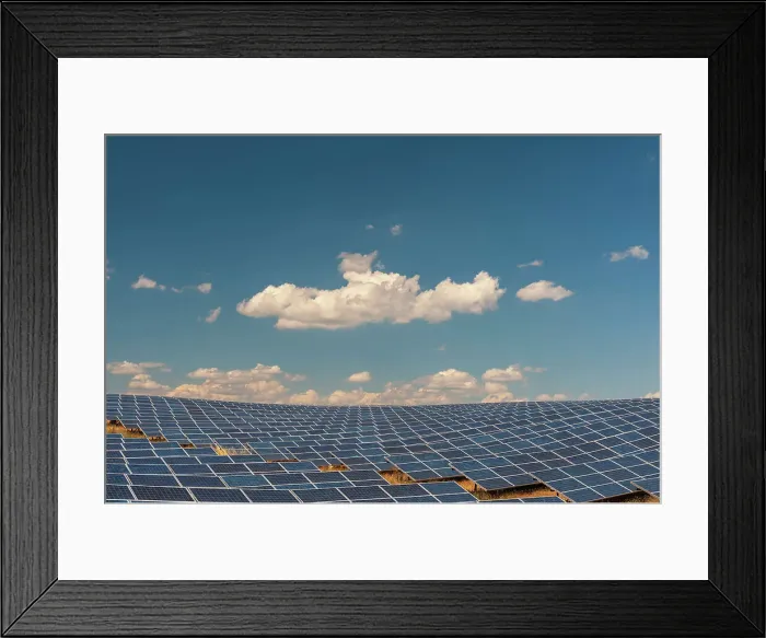Framed Print : A field of solar panels at a solar power plant under a blue sky with puffy white clouds. Les Mees, Provence, France